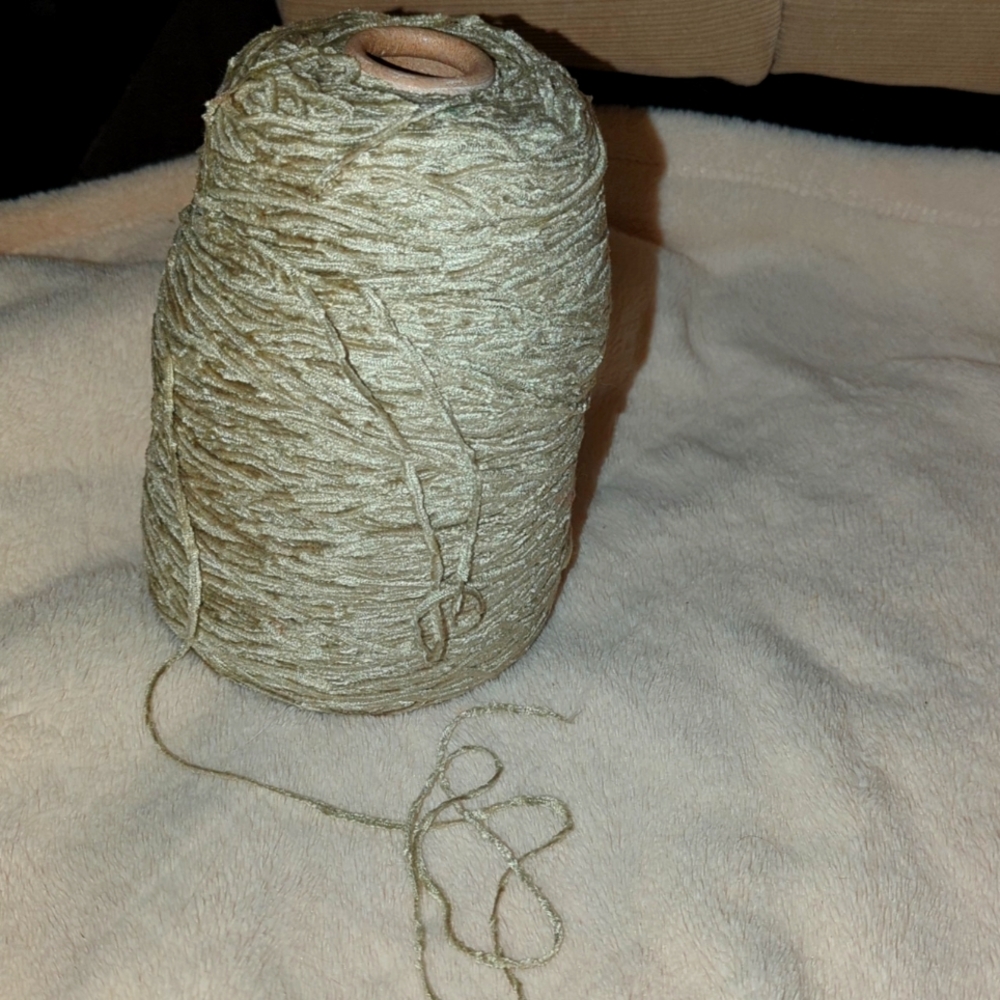 Spool of fingerling weight yarn, color silver sage